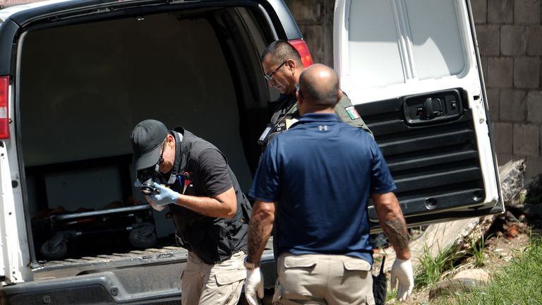 An investigator photographs a crime scene in Culiacan. Pic: Sky News