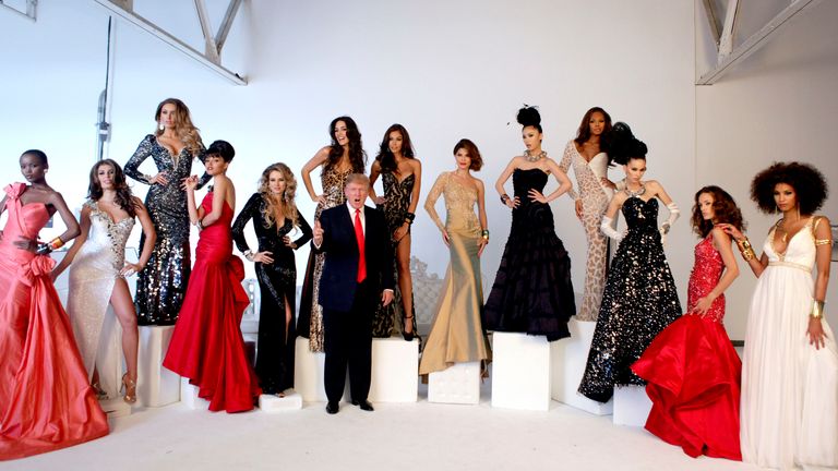 Donald Trump (C) poses with Miss Universe Beauty Queens (L-R) Flaviana Matata, Angela Martini, Rosanna Purcell, Susie Castillo, Shandi Finnessey, Amelia Vega, Dayanna Mendoza, Justine Pasek, Riyo Mori, Crystle Stewart, Zana Krasniqi, Marigona Dragusha, and Chloe Martaud during the pageant photoshoot in New York, July 27, 2011. REUTERS/Jamie Fine (UNITED STATES - Tags: ENTERTAINMENT BUSINESS)