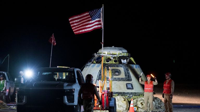 In this photo provided by NASA, Boeing and NASA teams work around NASA's Boeing Crew Flight Test Starliner spacecraft after it made an uncrewed landing in White Sands, New Mexico, Friday, Sept. 6, 2024, following undocking from the International Space Station. (Aubrey Gemignani/NASA via AP)