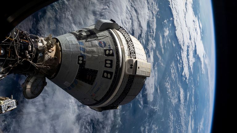 In this NASA photo, Boeing's Starliner spacecraft is docked to the International Space Station's Harmony module on July 3, 2024, as seen from a window of SpaceX's Dragon Endeavour spacecraft docked at an adjacent port. (NASA via AP)