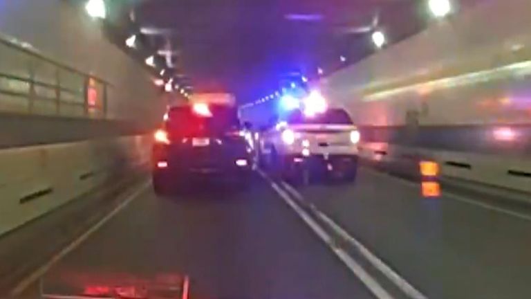 New York police chase a runaway taxi through a tunnel