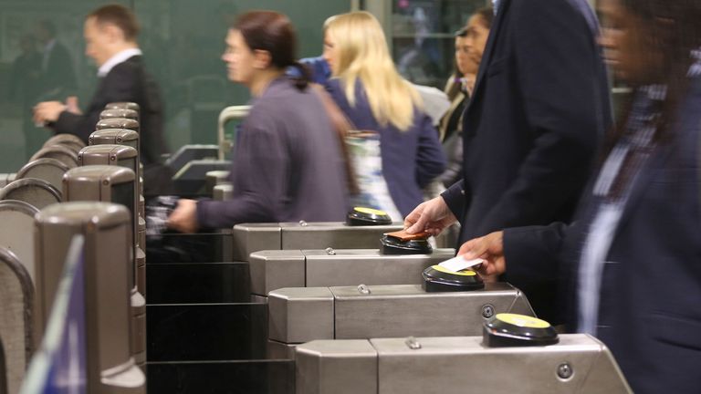 Customers using Oyster cards at the ticket barrier at Canary Wharf underground station in London.
Pic PA
