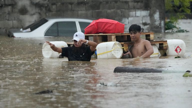 Residents wade with an improvised float as they cross a flooded street caused by heavy rains from Tropical Storm Yagi in Cainta, Rizal province, Philippines.
Pic: AP