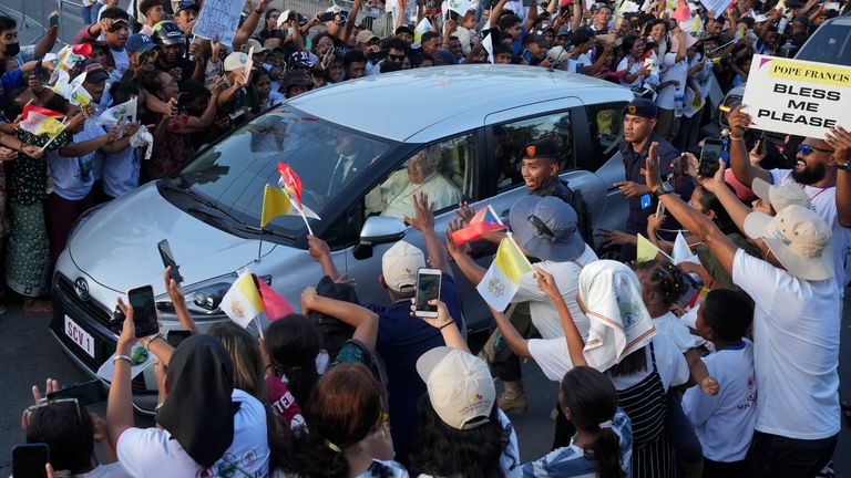 The pope travels to the presidential palace in Dili. Pic: AP