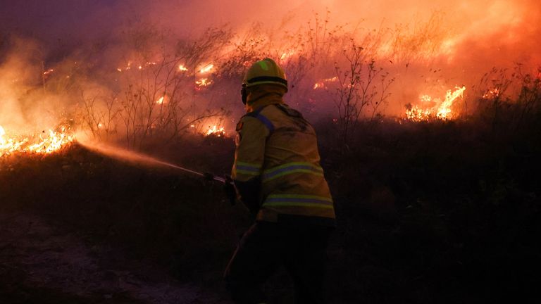 A firefighter works on a wildfire in Veiga, Agueda, Portugal, September 17, 2024. REUTERS/Pedro Nunes
