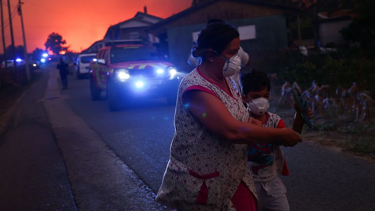 Pessoas abandonam as suas casas à medida que um incêndio florestal se aproxima, em Veiga, Águeda, Portugal, 17 de setembro de 2024. REUTERS/Pedro Nunes