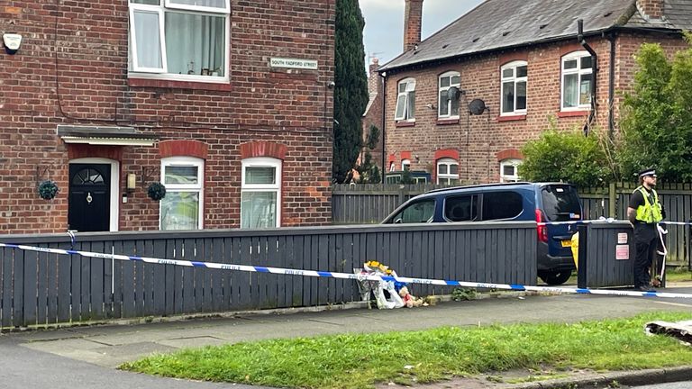 The scene in Salford where a 40-year-old woman and an eight-year-old girl have both been found dead inside a property