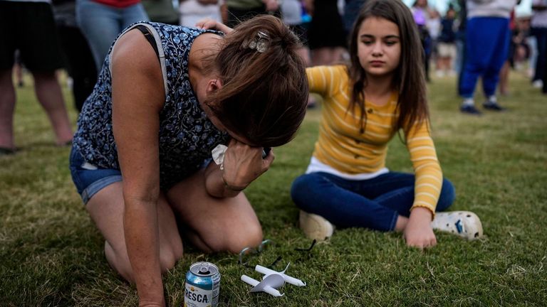 Brandy Rickaba and her daughter Emilie at a candlelight vigil for the victims of the school massacre. Photo: AP