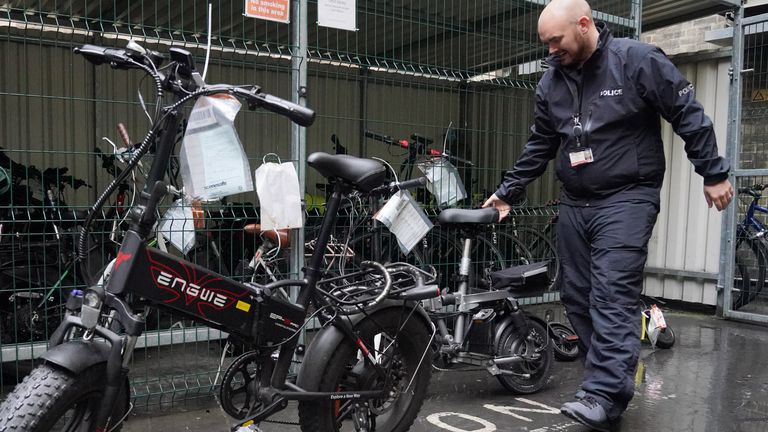 Sergeant Chris Hook handles confiscated illegally modified ebikes at Bishopsgate Police Station in London. Police seizures of illegally modified electric bikes (e-bikes) soared in the past year amid concerns their speed and weight present a lethal threat to pedestrians, according to Freedom of Information (FoI) figures obtained by the PA news agency. Forces across the UK confiscated 937 e-bikes in the year to August 11. Picture date: Thursday September 12, 2024.