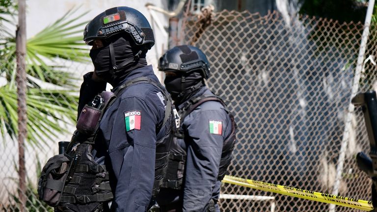 Sinaloa state police at the scene where two men's bodies were discovered in Culiacan. Pic: Sky News