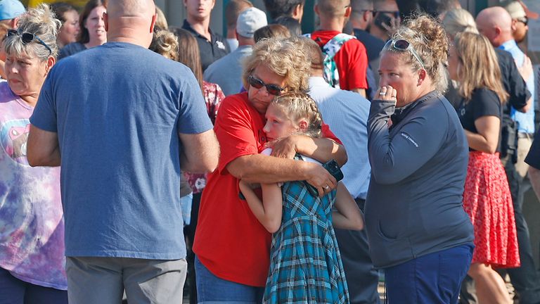 Family members are reunited with their children at the German Township Government Center following a Northwestern School District bus crash on State Route 41 in Springfield, Ohio, Tuesday, Aug. 22, 2023. (Bill Lackey/The Springfield News-Sun via AP)