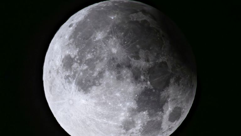 A supermoon with partial solar eclipse rises over Brandenburg, Biegen, Germany. Image: AP