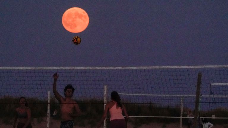 The supermoon rises over a beach in Chicago. AP