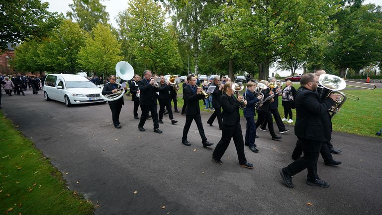 The procession walks through the town of Torsby after the funeral. Pic: PA