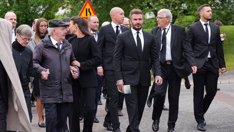 David Beckham walks among mourners after the funeral. Pic: PA