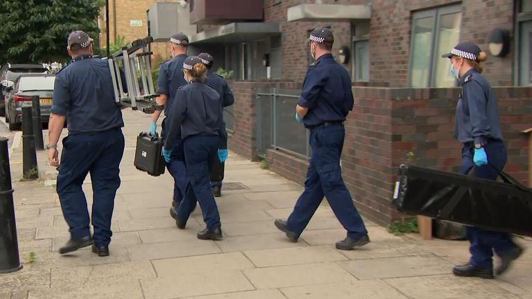Forensics officers leaving the scene