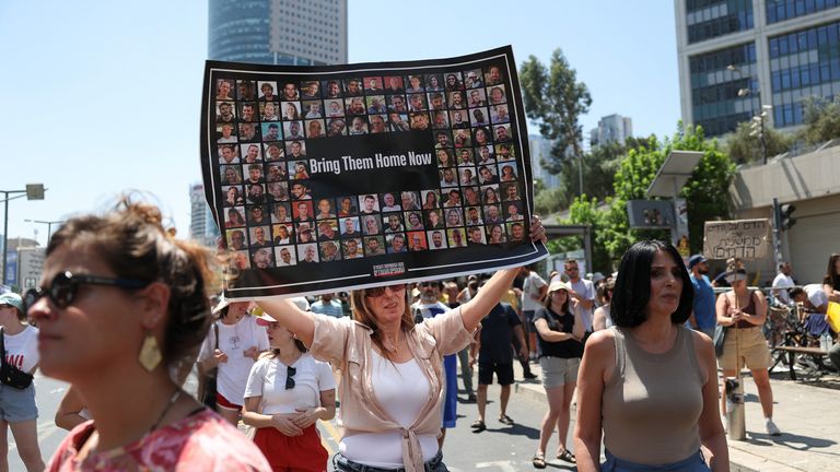 A demonstrator holds a sign in Tel Aviv. Pic: Reuters