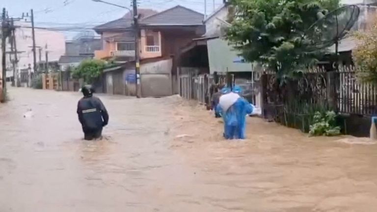 People wade through floodwaters following the impact of Typhoon Yagi in Chiang Rai province, Thailand, September 11, 2024, in this still image taken from a video. Tubjaotak Task Force, Pha Muang Force/Handout via REUTERS THIS IMAGE HAS BEEN SUPPLIED BY A THIRD PARTY