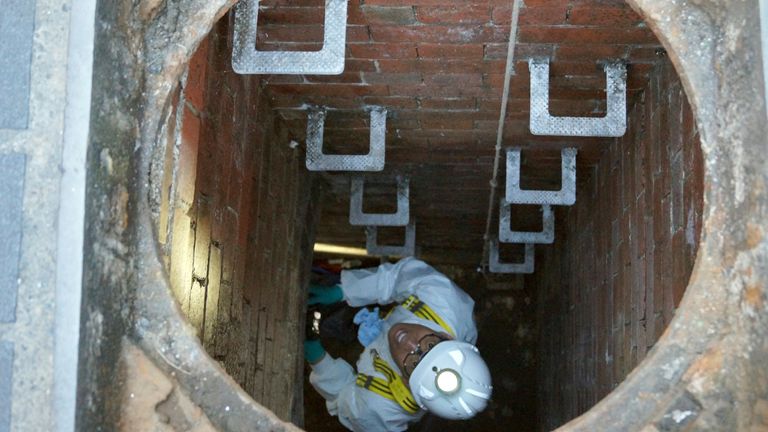 A Thames Water employee climbs down into a sewage pipe in London. File pic: PA