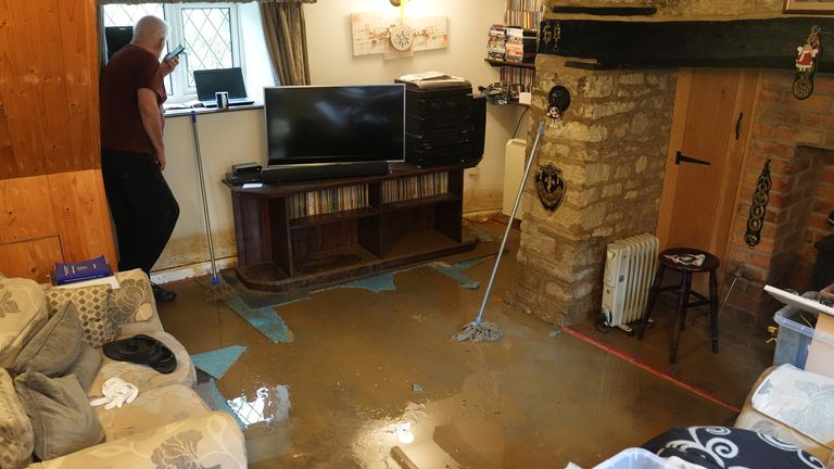 Tim Maher looking out of the window of his flooded house in Grendon, Northamptonshire. Pic: PA