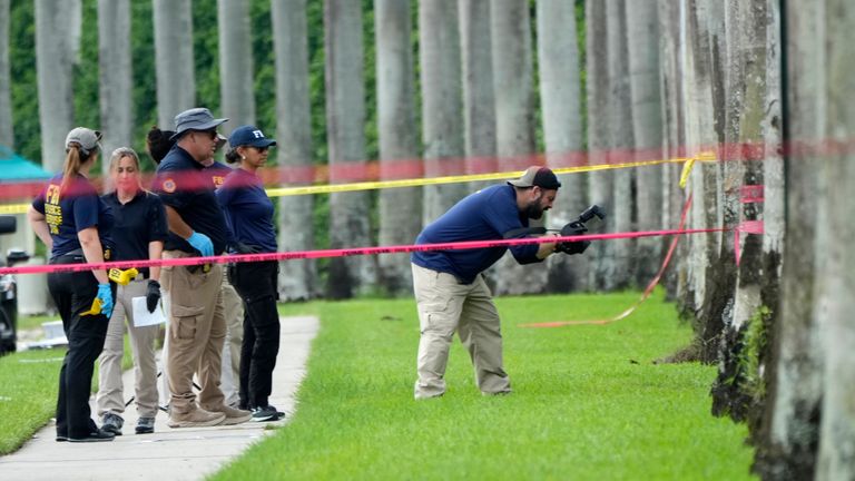 Law enforcement officials work outside of the Trump International Golf Club yesterday. Pic: AP