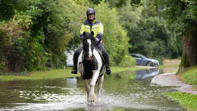 Lynsey Ellis and her horse Scrumpy navigate a flooded road in Harrold, Bedfordshire. Photo: PA