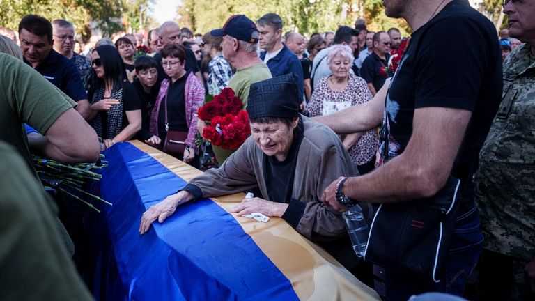 Mourners at Saturday's funeral for those killed in a Russian attack on Poltava this week. Pic: AP