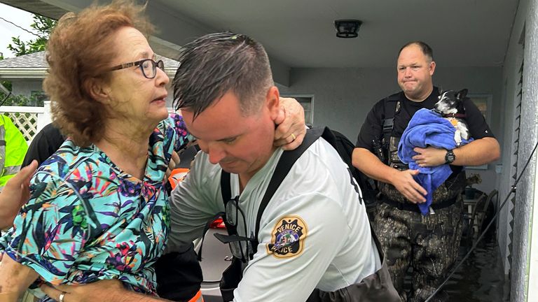 This photo provided by Venice Police Department rescue crews assist residents after conducting door-to-door wellness checks, in coastal areas that were flooded by Hurricane Helene on Friday, Sept. 27, 2024 in Venice, Fla . (Venice Police Department via AP)