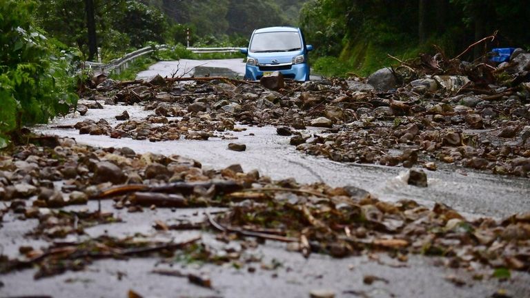 Japan Heavy Rain
A car is blocked by rocks covering a road, after heavy rain in Wajima, Ishikawa prefecture, Saturday, Sept. 21, 2024. (Kyodo News via AP)

