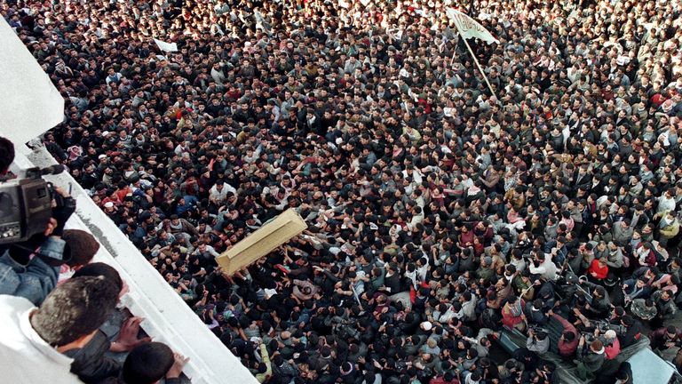 The coffin of Yahya Ayyash is carried into the Palestine mosque for funeral services January 6 as the crowd of Hamas movement supporters rushes to touch the plain wooden coffin. Ayyash, known as "The Engineer", was killed yesterday when a booby-trapped cellular telephone exploded. He was responsible for the death of dozens of Israelis in suicide bombings and topped Israel's most-wanted list. Tens of thousands of Palestinians turned out for his funeral and vowed revenge against Israel