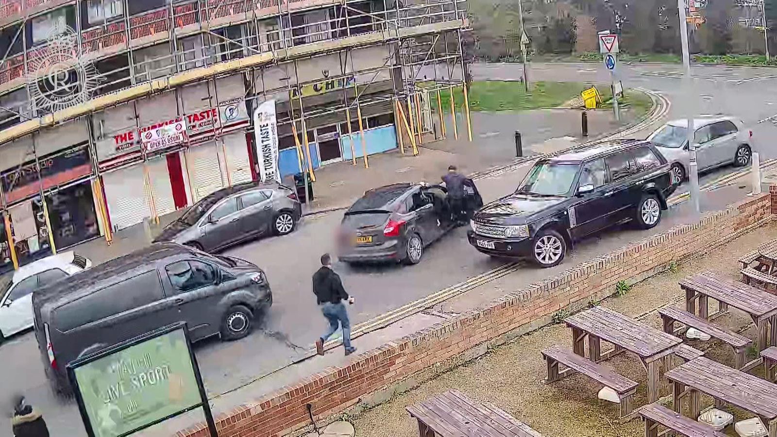 A police officer clung to the side of a car as a suspected drug dealer