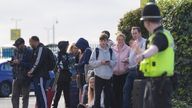 Passengers wait to enter Birmingham Airport after it was evacuated following a security alert. 
Pic: PA