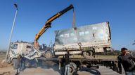 Palestinians work to remove an UNRWA-labelled vehicle after it was hit in an Israeli strike, according to Palestinian officials in Deir Al-Balah.
Pic: Reuters
