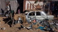 Palestinians stand near a destroyed car at the site of an Israeli strike on a house, in Khan Younis in the southern Gaza Strip October 25, 2024. REUTERS/Mohammed Salem TPX IMAGES OF THE DAY
