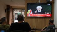 People watch Hezbollah deputy leader Sheikh Naim Qassem delivering a televised address, as they sit in a cafe in Beirut.
Pic: Reuters