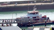A group of people thought to be migrants are brought in to Dover, Kent, from a Border Force vessel on 18 October. Pic: PA