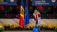 A woman mops a stage before an electoral rally in Moldova. Pic: AP