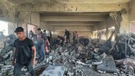Palestinians inspect the site of an Israeli strike on a school sheltering displaced people in Nuseirat.
Pic: Reuters