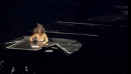 The moment the popstar fell into a hole on stage. 
Pic: AP