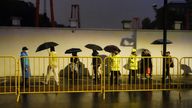 Police officers keep watch near barricades set up along Julu Road where people in Halloween costumes gathered the year before, in Shanghai, China October 26, 2024. REUTERS/Nicoco Chan