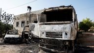 A Palestinian man inspects the damage after Israeli settlers attacked a village in the Israeli-occupied West Bank in April. Pic: Reuters