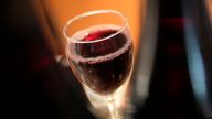 A glass of Beaujolais Nouveau wine is pictured in a restaurant of Boulogne Billancourt, outside Paris, Thursday, Nov. 18, 2021. Each year, on the third Thursday in November at the stroke of midnight, the world welcomes in the new Beaujolais Nouveau vintage, a light red wine, produced in the Beaujolais region of southern Burgundy. (AP Photo/Christophe Ena)