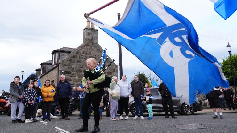 A piper plays outside after the coffin of former first minister of Scotland Alex Salmond was taken into Fraserburgh Funeral Services, after his repatriation to the UK following his death on Saturday afternoon at the Institute for Cultural Diplomacy Forum in the North Macedonia lake-resort town of Ohrid. Picture date: Friday October 18, 2024.