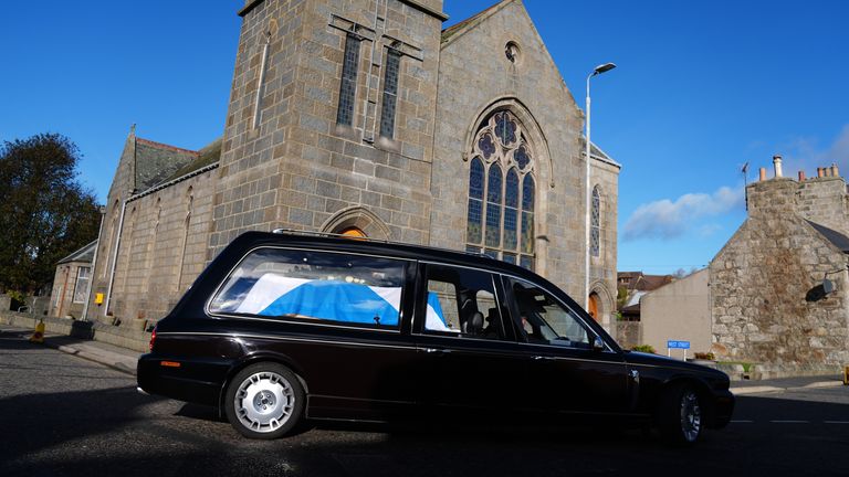 The hearse carrying the coffin, draped in a Saltire flag, arrives for the funeral service of former first minister of Scotland Alex Salmond, at Strichen Parish Church in Strichen, Fraserburgh. The former Alba Party and SNP leader died of a heart attack while attending a conference in North Macedonia earlier this month. Picture date: Tuesday October 29, 2024.