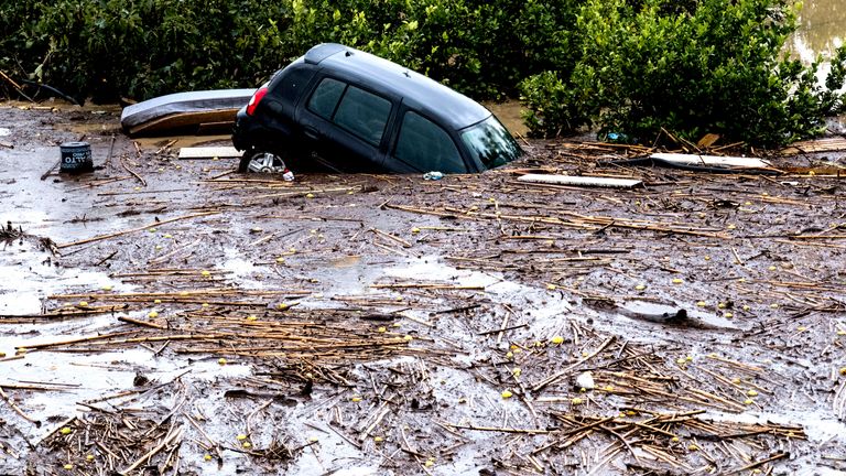 Cars are swept away by water after flooding preceded by heavy rain caused the river to overflow its banks in the town of Alora, Malaga, Tuesday, October 29, 2024. (AP Photo/Gregorio Marrero)