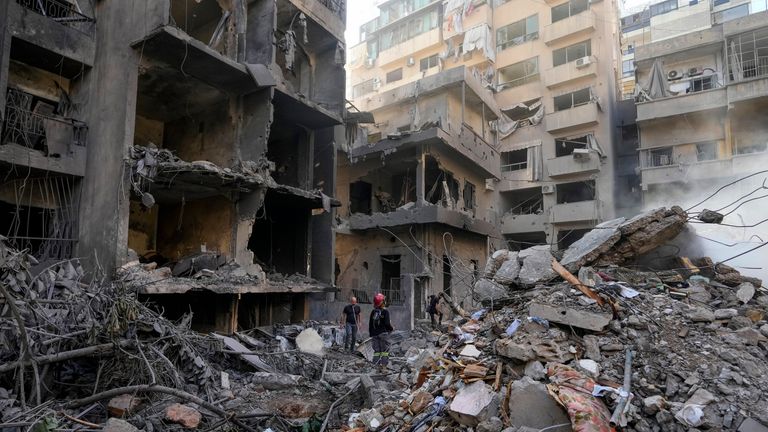 Rescue workers search for victims at the site of Thursday's Israeli airstrike in Beirut, Lebanon, Friday, Oct. 11, 2024. (AP Photo/Hassan Ammar)