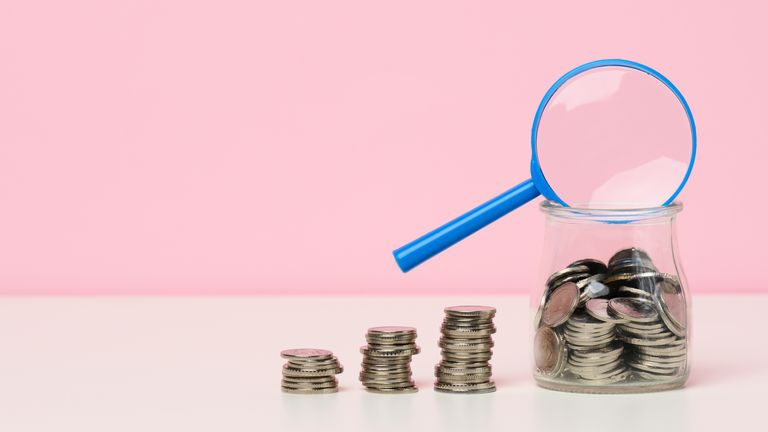 blue magnifier and white coins on the table