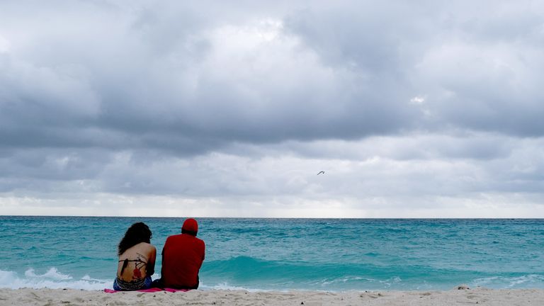 A couple sits on the beach as Hurricane Milton advances past Mexico's Yucatan Peninsula on its way to Florida.
Pic: Reuters