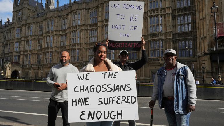 Chagossians Whitney Tranquille, center, attends a protest to response the U.K. announcement to agree to hand sovereignty of the long-contested Chagos Islands to Mauritius and against their "Exclusion" from Chagos negotiations, outside the House of Parliament, in London, Monday, Oct. 7, 2024. (AP Photo/Kin Cheung)