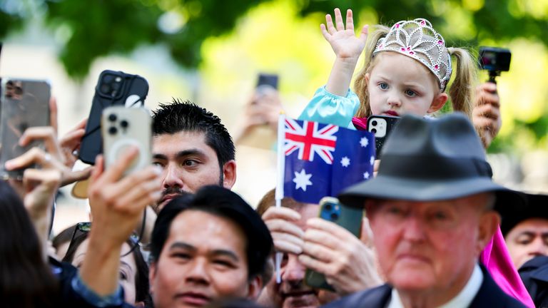 A young girl wearing a toy crown in a crowd of wellwishers wait to see King Charles III and Queen Camilla outside a Sunday church service at St Thomas' Anglican Church in north Sydney, on day one of their visit to Australia and Samoa. Picture date: Sunday October 20, 2024.

